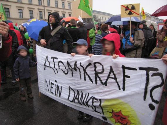 Demonstranten halten ein Stoffplakat mit dem Slogan "Atomkraft? Nein Danke!"