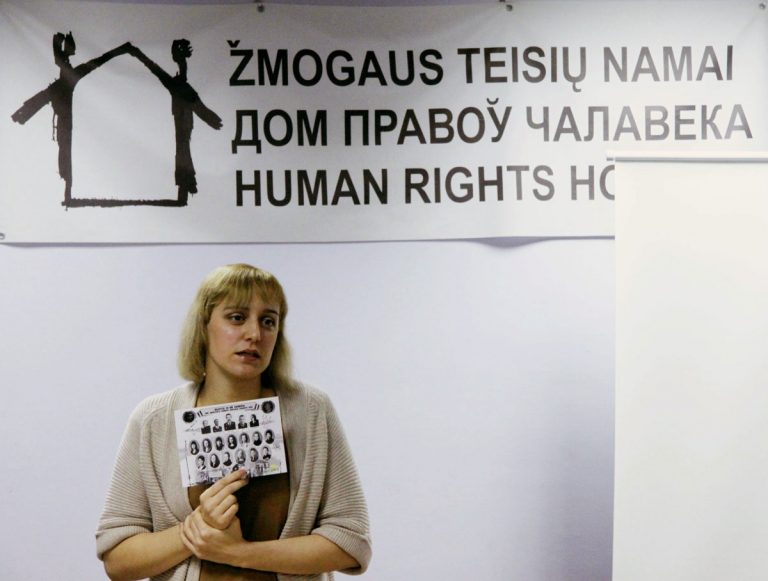 Aktivistin Olga Karatch hält ein Schild in der Hand,