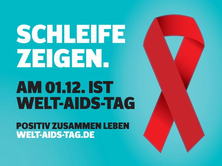 Schriftzug "Schleife zeigen. Am 01.12. ist Welt-AIDS-Tag. Positiv zusammen leben. welt-aids-tag.de", neben einer roten Schleife